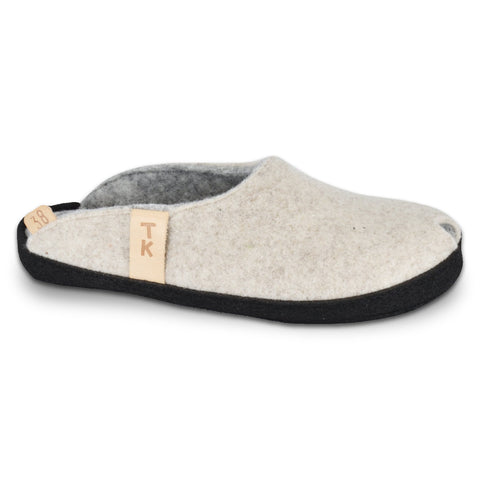 1. TOKU Brussels natural white slippers in studio, showcasing black microfibre sole and lambswool felt upper