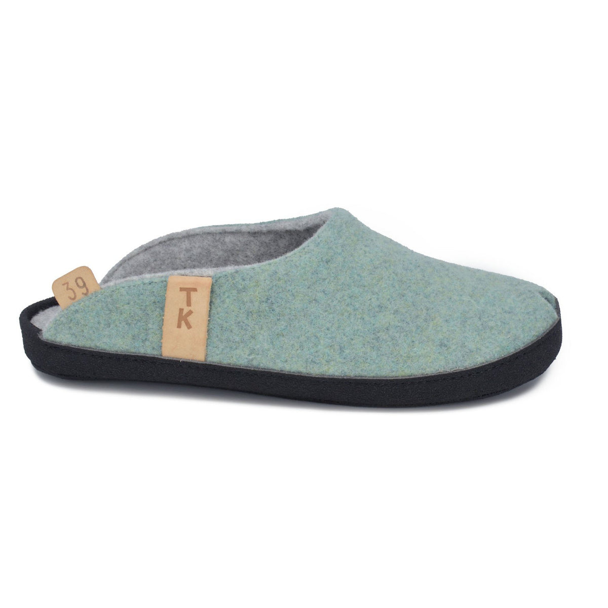 1. Omaking TOKU Brussels slippers in mint green, side view showing natural lambswool felt and black microfibre sole