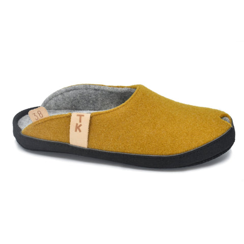 3. Side view of TOKU Brussels mustard yellow slippers with black microfibre sole and TK branding, highlighting arch support design