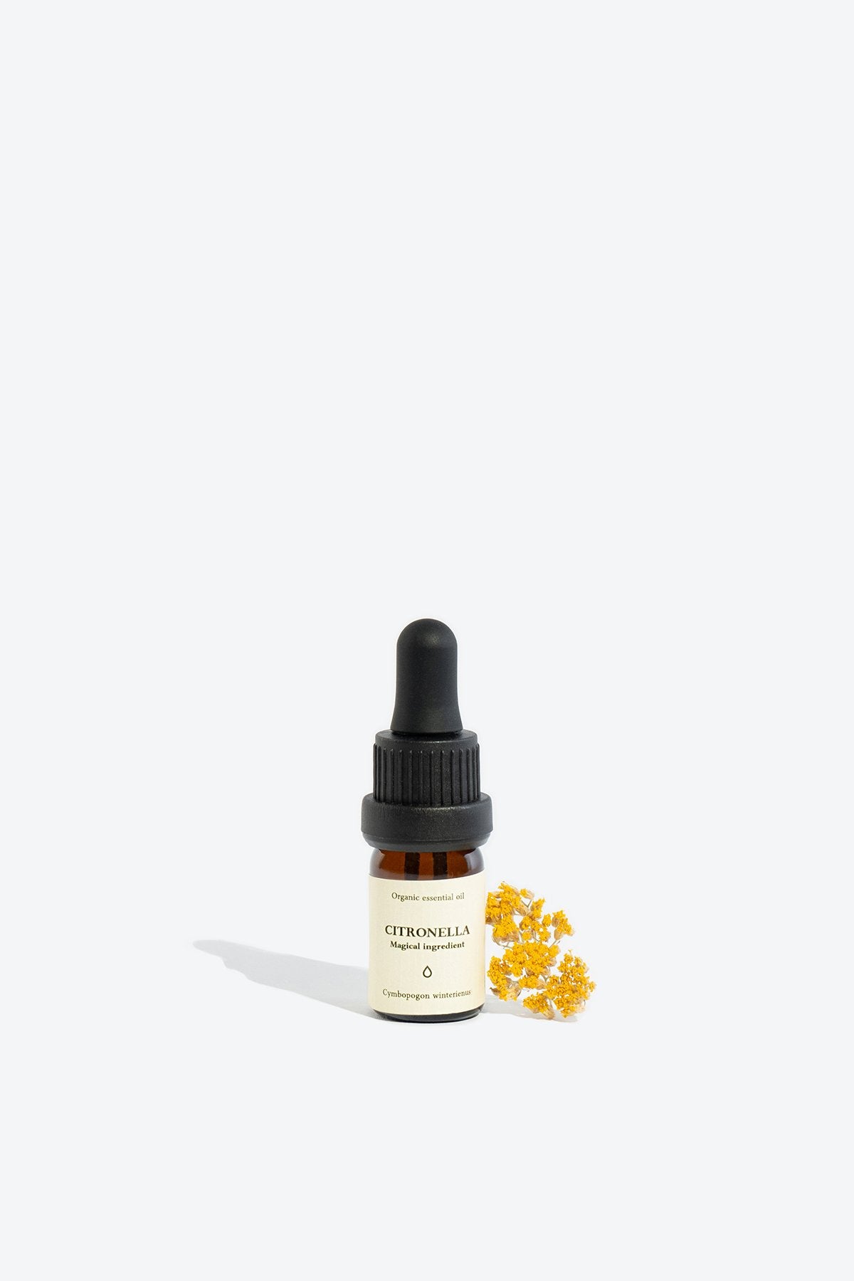 1. Smells Like Spells CITRONELLA Essential Oil in 5 ml glass bottle with pipette, shown with yellow flower accent