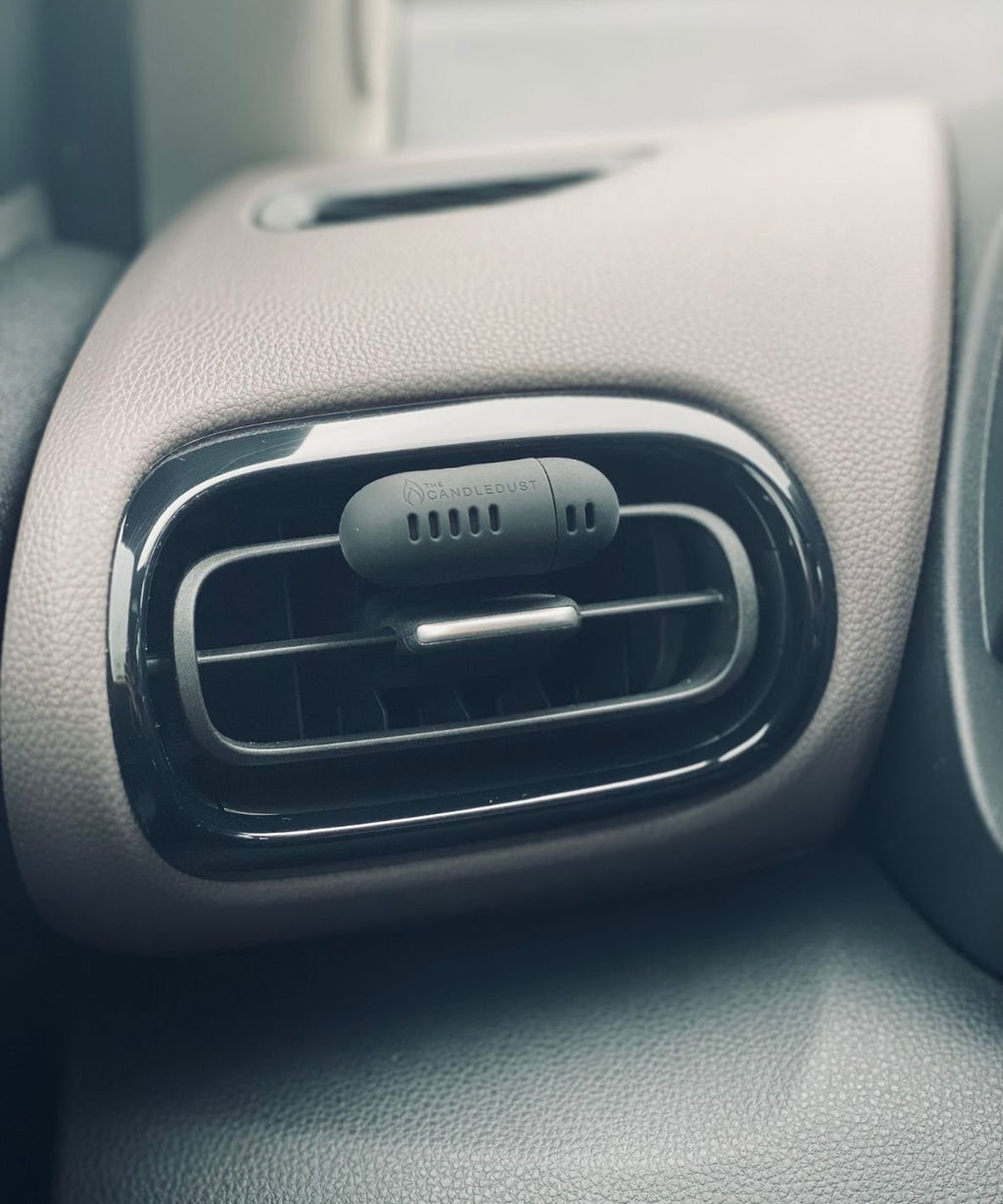 2. Candledust Signature car diffuser attached to car air vent, showcasing compact design