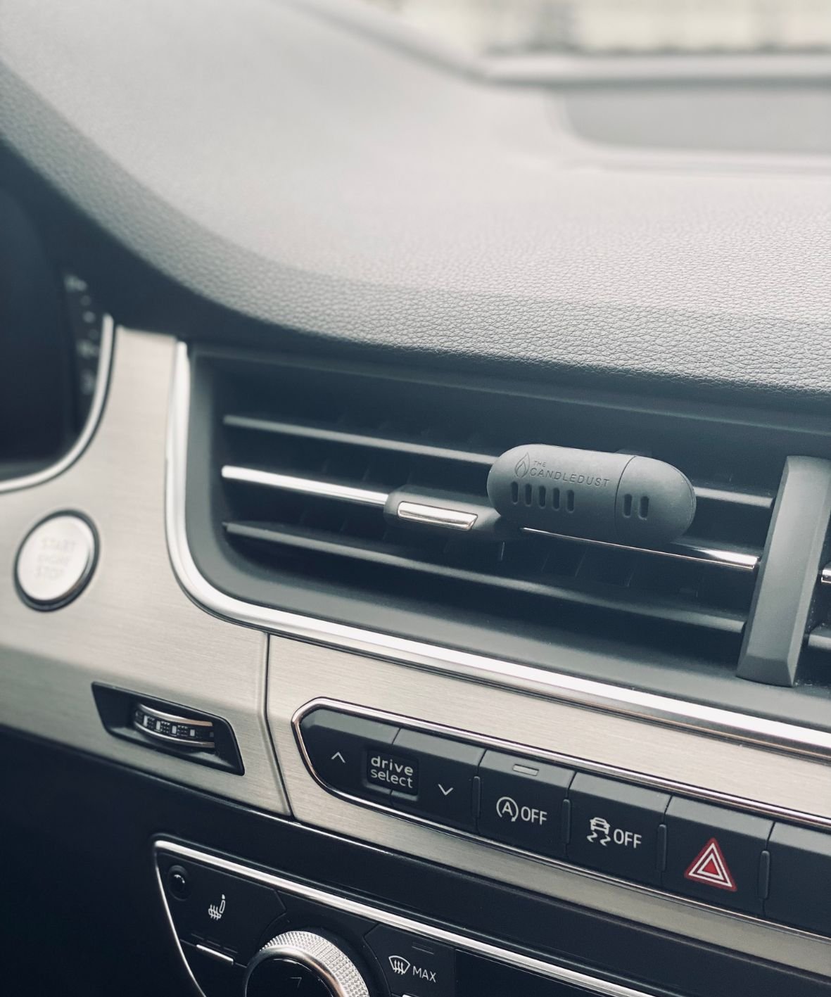 3. Candledust Champagne Rhubarb car diffuser on dashboard vent, emphasizing modern car interior integration
