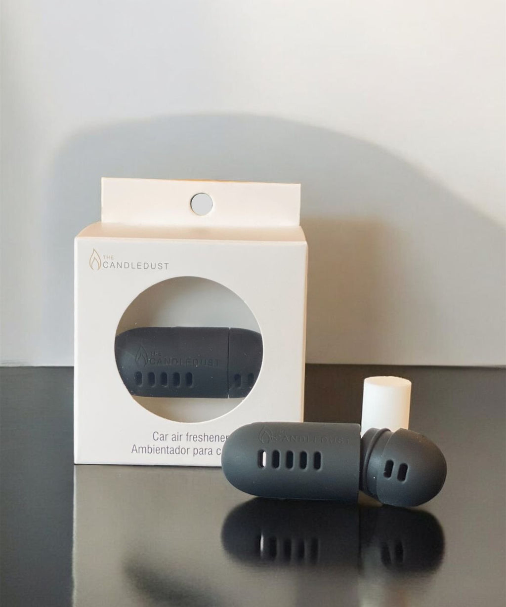 4. Candledust Breeze car diffuser with packaging and refill capsule, displayed on a black surface