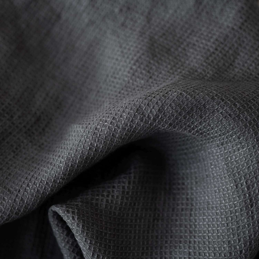 6. Close-up of charcoal waffle linen fabric texture, highlighting weave detail