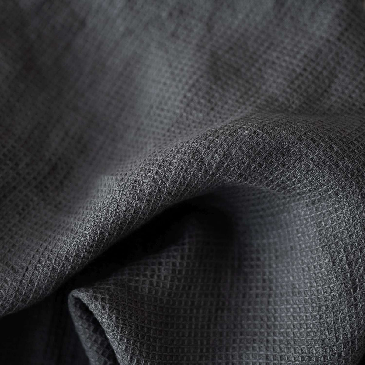 6. Close-up of charcoal waffle linen fabric texture, highlighting weave detail