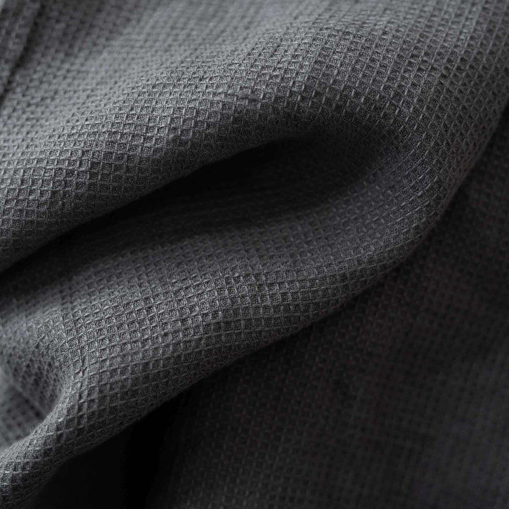 7. Detailed view of charcoal waffle linen fabric showing fine texture and weave