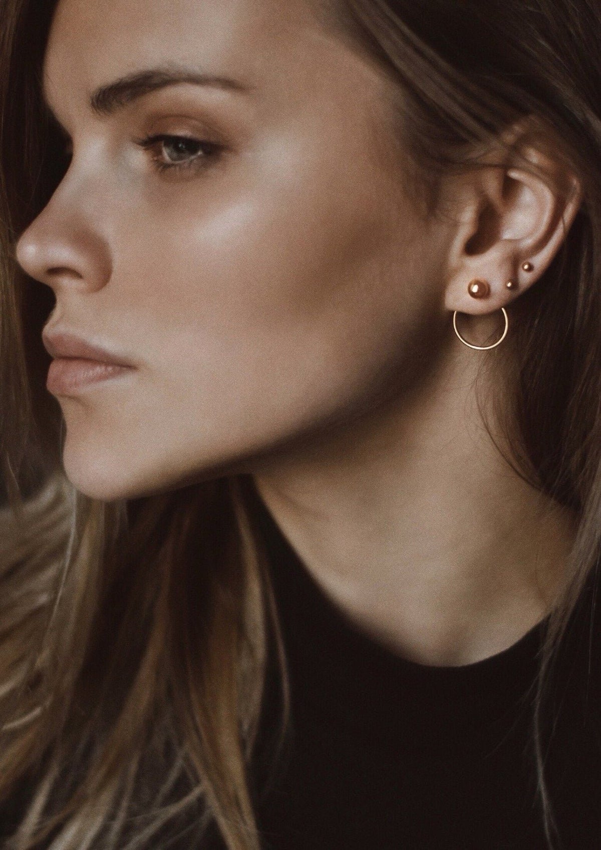 1. Women's Chord Earrings in gold by NO MORE, worn by model, showcasing front-facing design with ball and circle detail
