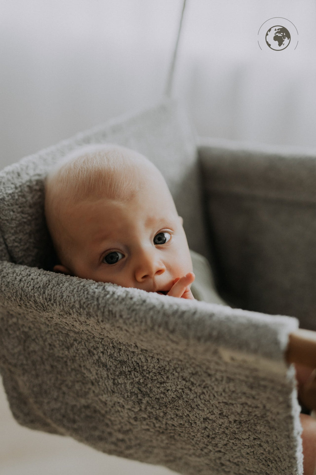 4. Baby sitting in bouclé stone grey swing with oak wood poles