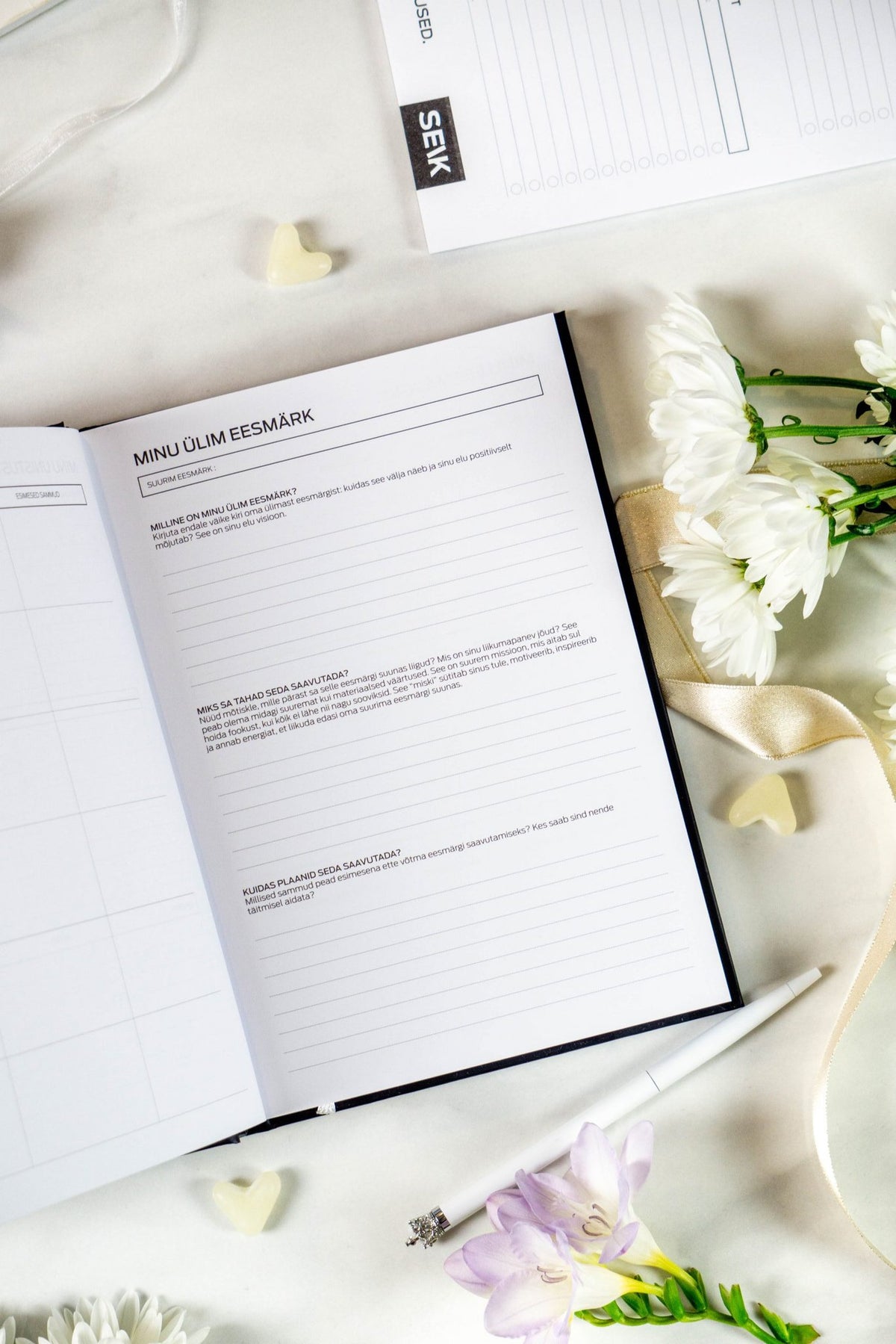 5. Get (sh)it done #Produktiivsuspäevik planner open to lined pages for notes, with flowers nearby