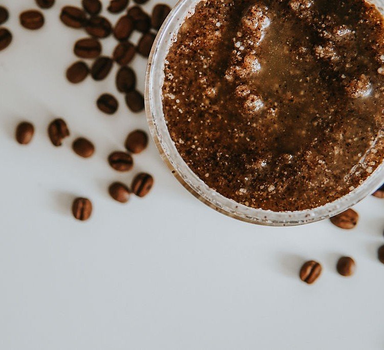 5. Close-up of Vegan Fox Coffee Body Scrub texture with coffee beans, highlighting exfoliating particles