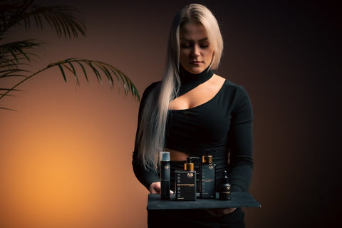1. Woman holding North Beauty men's grooming products, including 2 in 1 shower gel with aloe vera, in a lifestyle setting