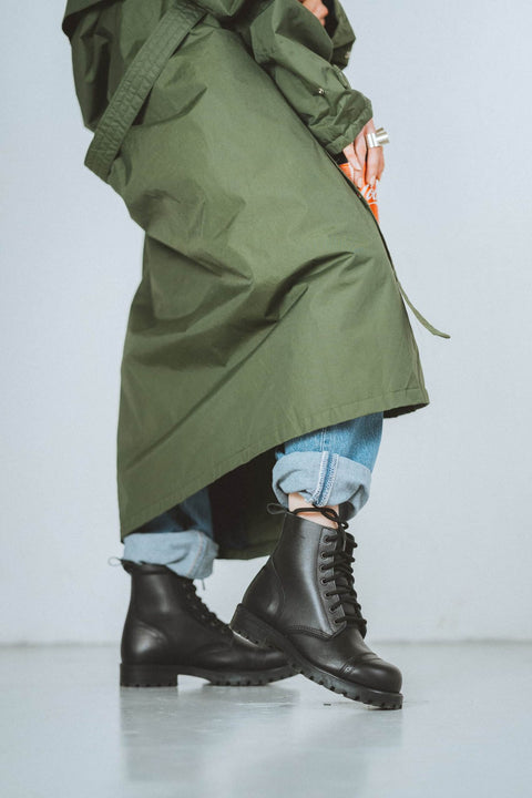 3. Woman in Samelin 517 Aviator Boots, black, styled with green coat and jeans, casual pose