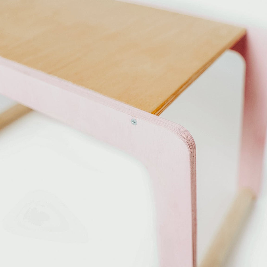 3. Close-up of corner detail on children's desk with pink legs and wood top