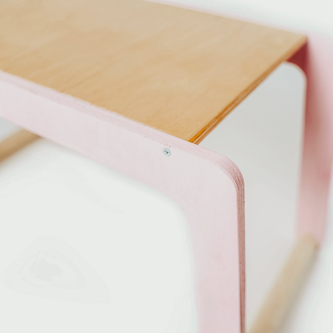 3. Close-up of corner detail on children's desk with pink legs and wood top