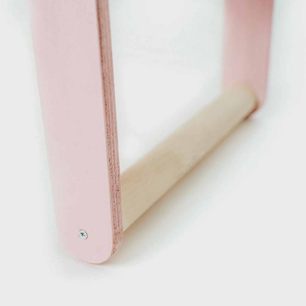 3. Close-up of pink leg and natural wood bar of children's desk