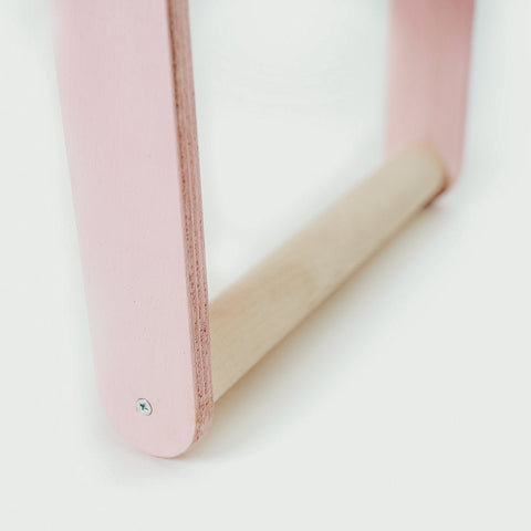 3. Close-up of pink leg and natural wood bar of children's desk