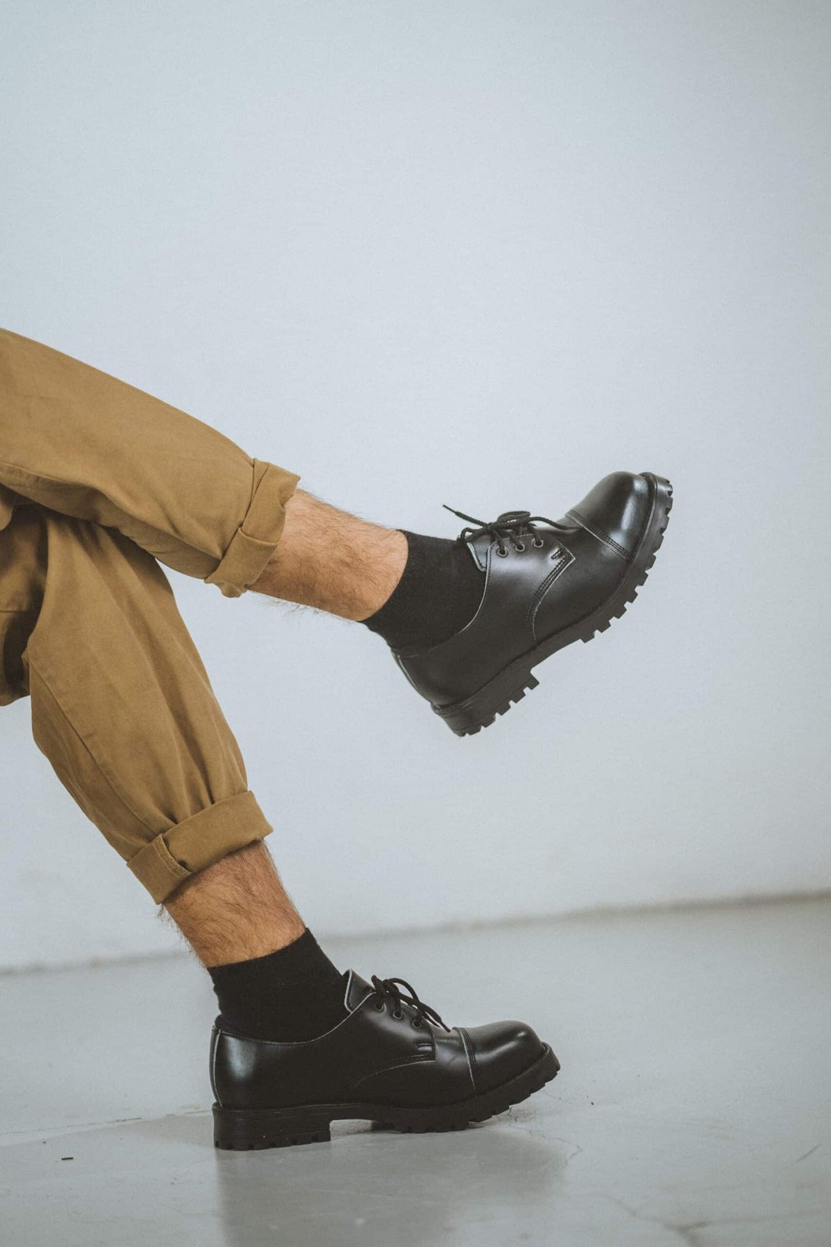 3. Close-up of unisex black Samelin Widgets worn by male model, showing side view