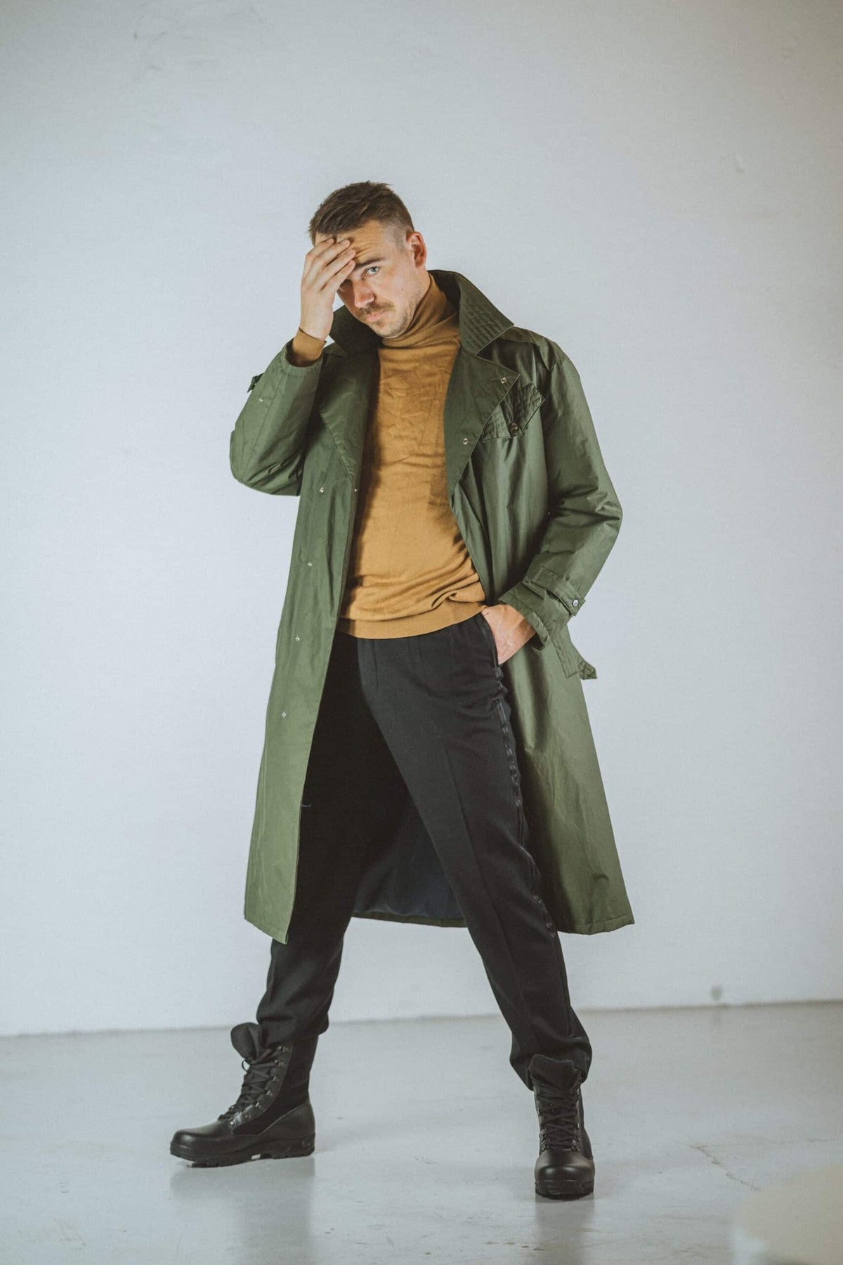 1. Men's black Samelin 598 Desert Boots Davos styled with green trench coat and black pants in lifestyle setting