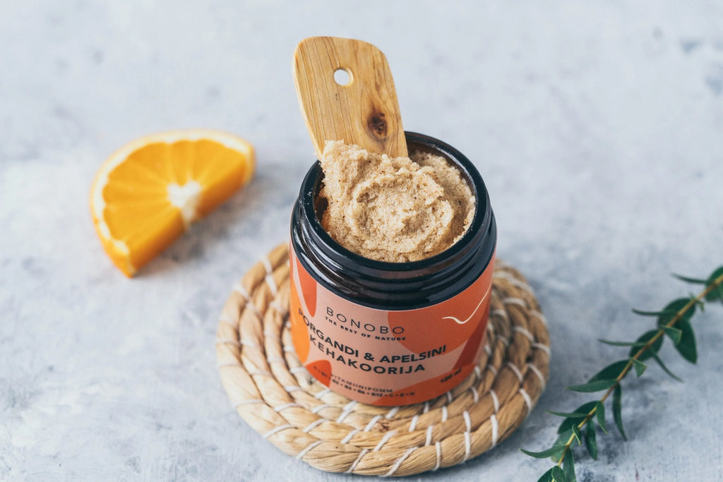 3. BONOBO orange and carrot body scrub with wooden spoon, highlighting texture and natural ingredients