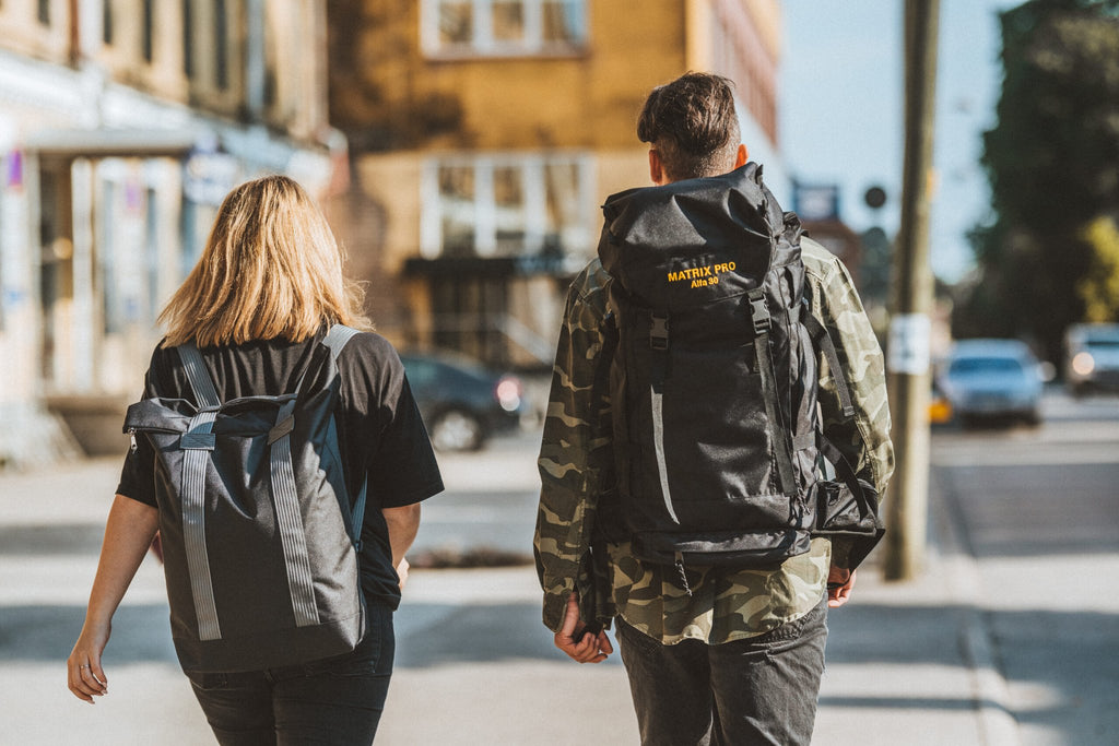 3. Back view of man and woman with Matrix Pro Alfa 30 hiking bag on city street