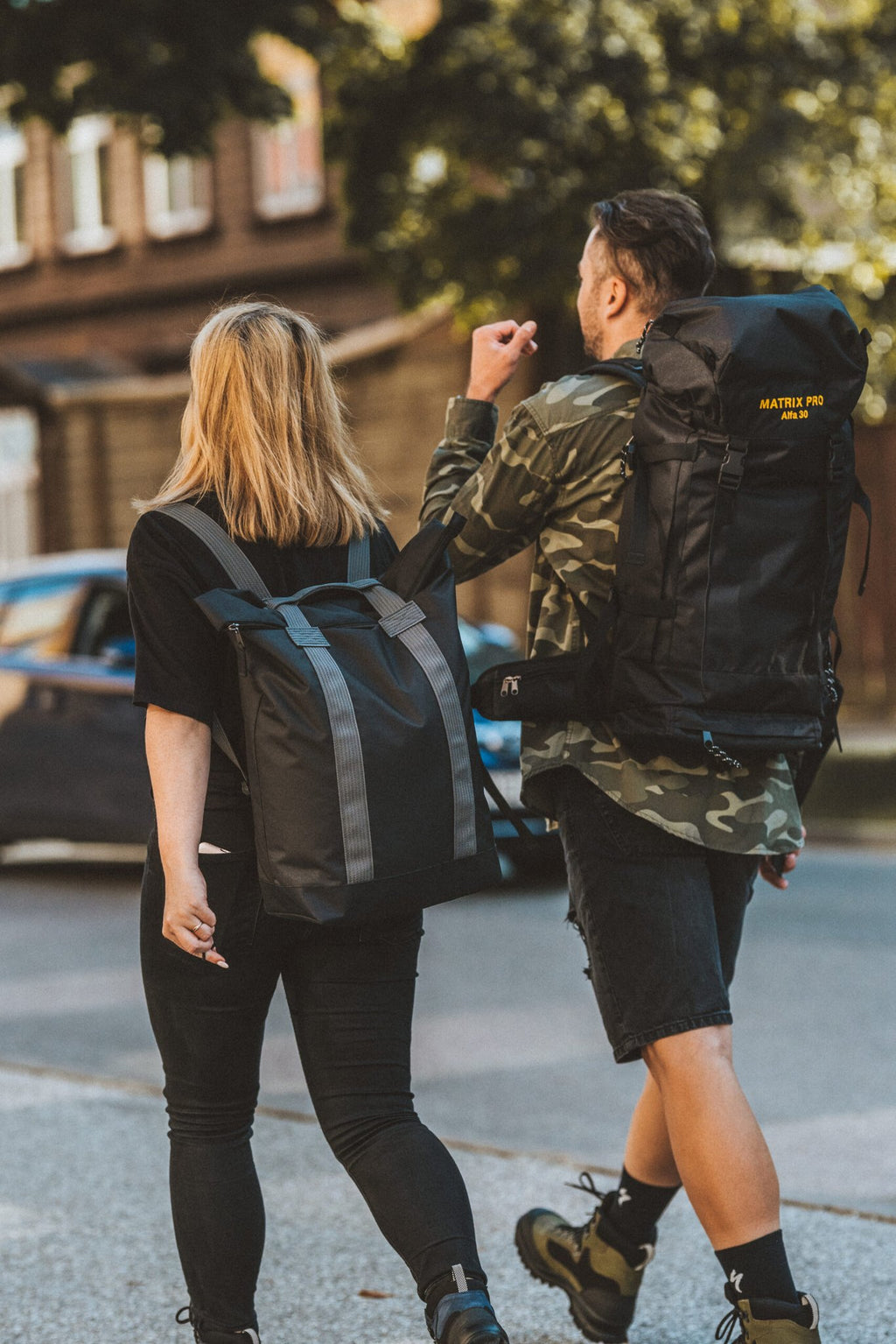 2. Man and woman walking with Matrix Pro Alfa 30 hiking bag in urban environment
