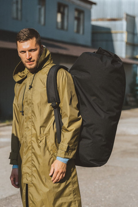 1. Men's black Galvi Linda Duffle Bag 047 worn over shoulder, outdoor setting