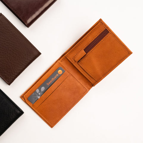2. Open Cognac Papillon Leather Wallet No. 21 displaying card slots and zippered coin pocket