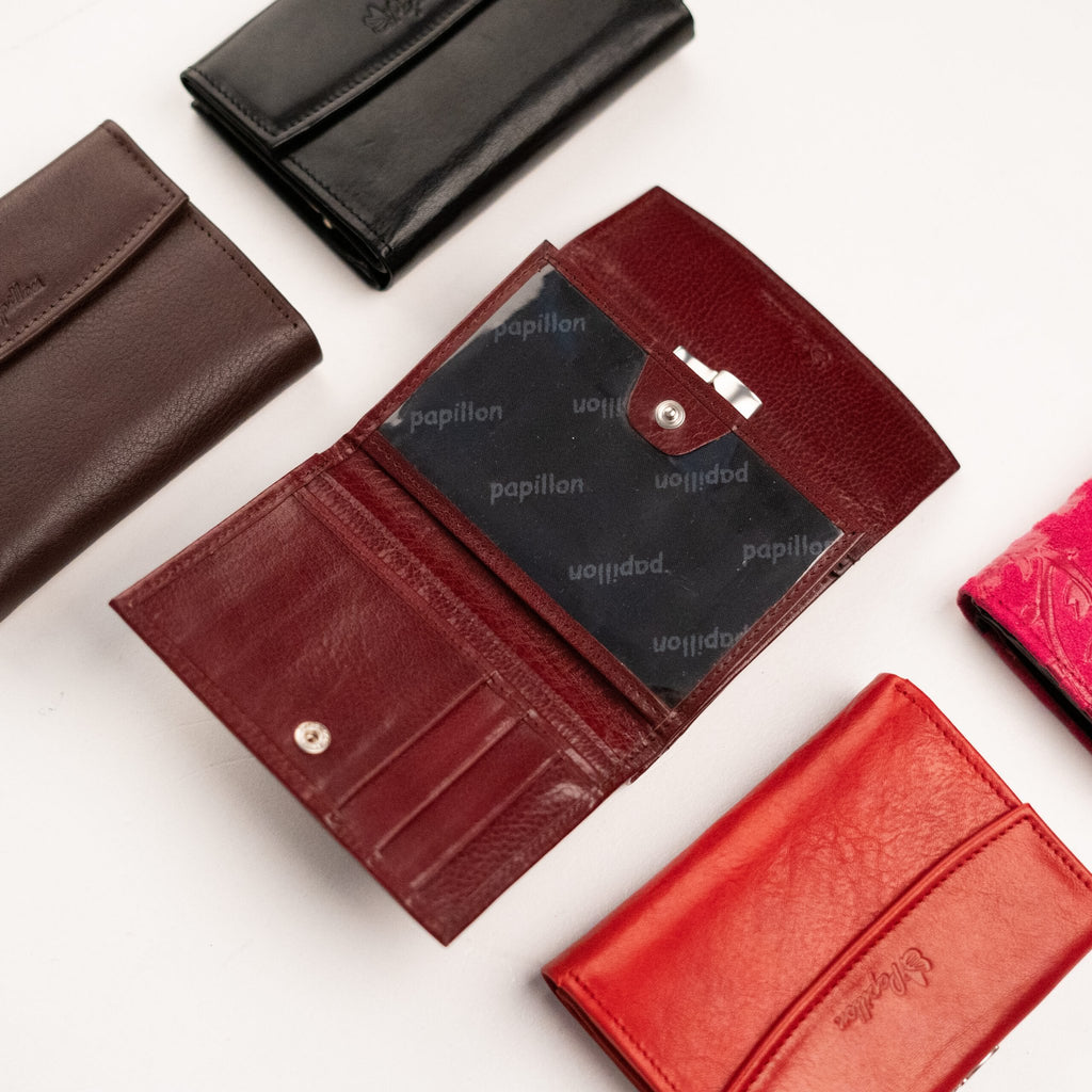 4. Open Papillon women's leather wallet displaying clear pocket and card slots, surrounded by other color options