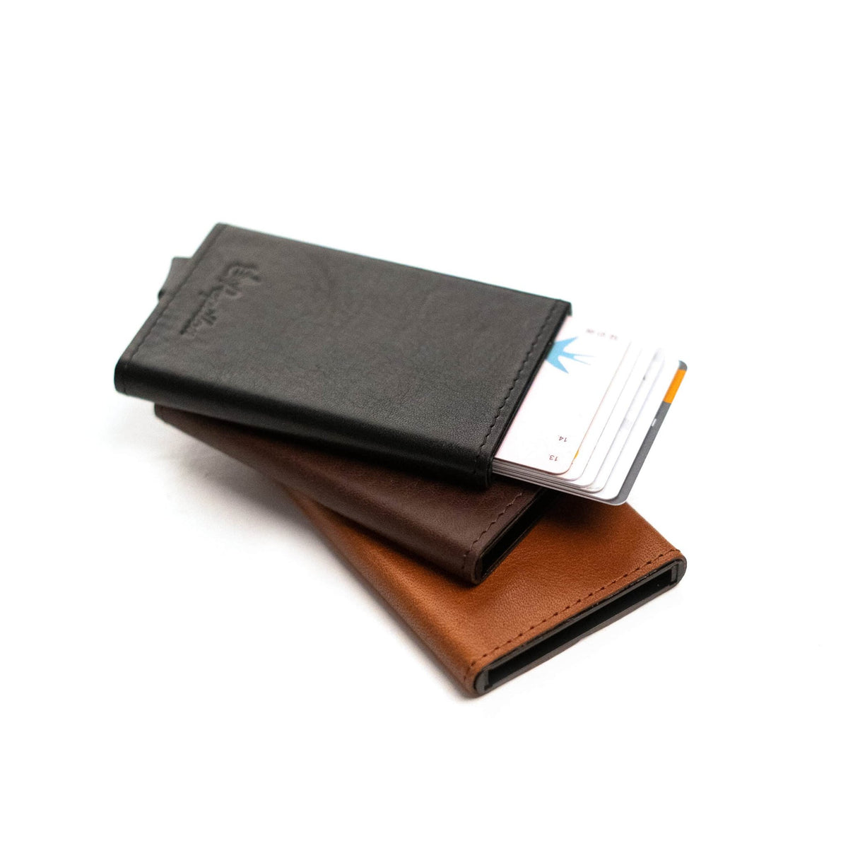 3. Papillon Card Holder No. 40 in black, brown, and cognac leather with cards partially ejected, highlighting functionality