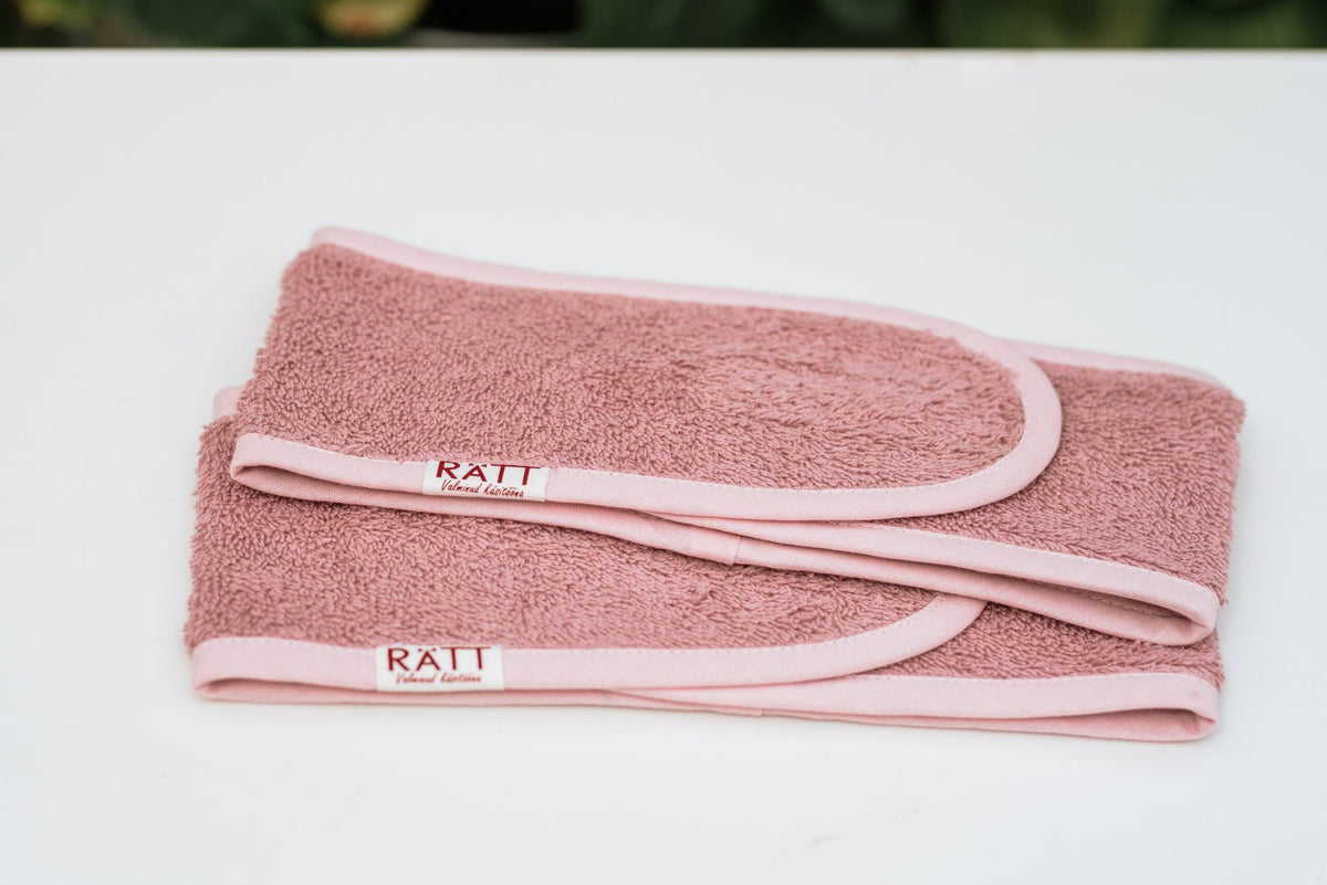 5. Flat lay of two pink RÄTT cotton terry headbands, showing wide design and branding