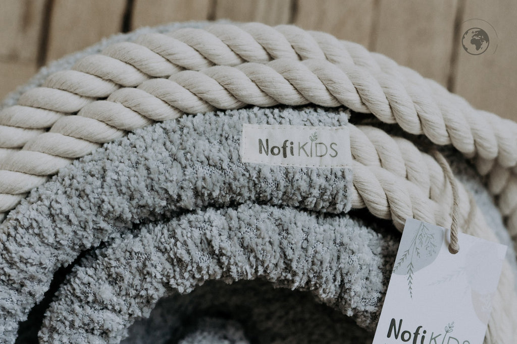 4. Detail of Nofi KIDS HopOn Swing showing bouclé stone grey fabric and cotton rope with brand tag