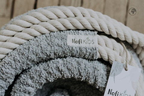 4. Detail of Nofi KIDS HopOn Swing showing bouclé stone grey fabric and cotton rope with brand tag