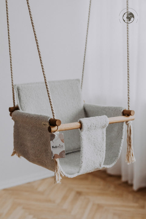 4. Nofi KIDS bouclé ice grey baby swing with oak wood poles hanging indoors