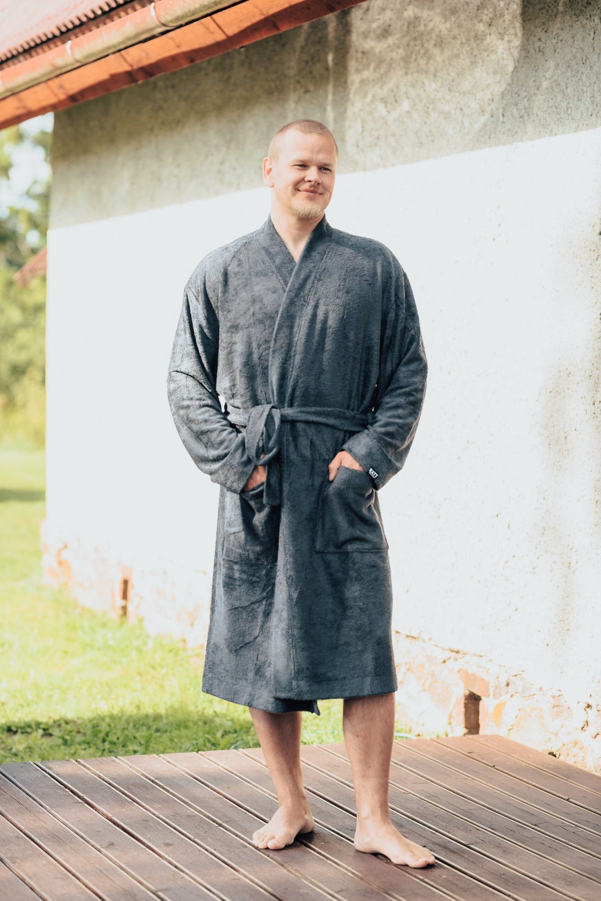 2. Men's bamboo terry bathrobe by RÄTT, shown outdoors with belt closure and pockets