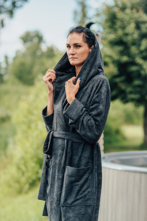 3. Women's black bamboo terry bathrobe with hood, shown outdoors with hands holding the hood