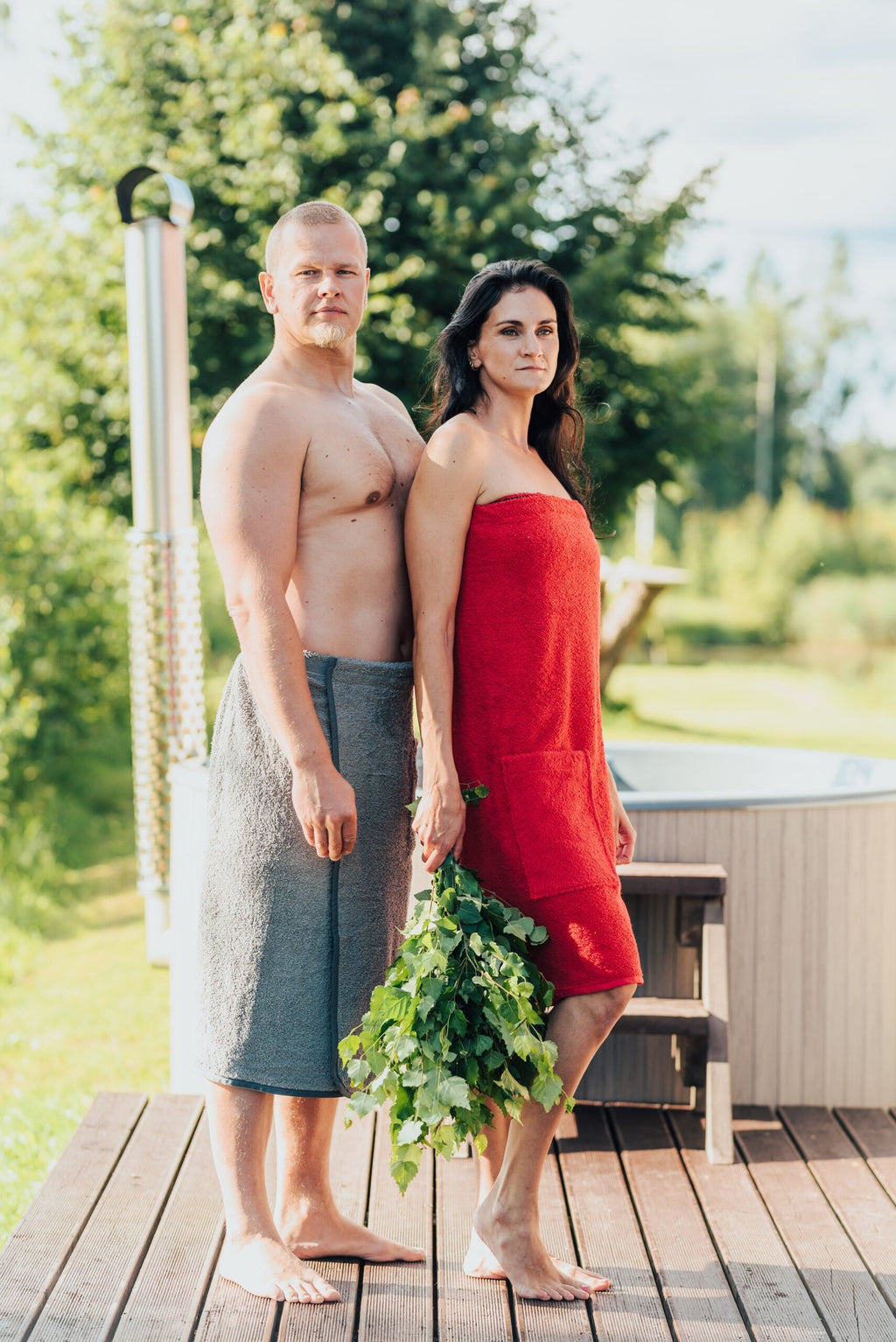 1. Men's gray RÄTT spa wrap worn by male model outdoors, perfect for sauna or home lounging