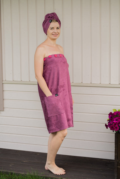 5. Women's dark dusty pink bamboo terry spa wrap by RÄTT, worn by model outdoors, highlighting button closure and pocket