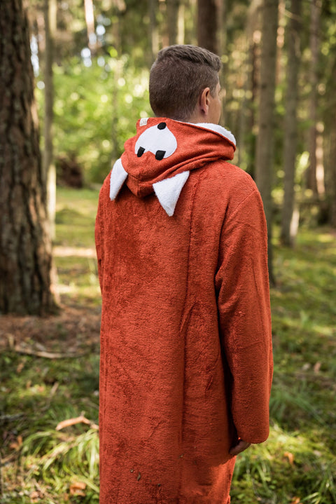 2. Back view of men's long-sleeve poncho FOX with hood detail in bamboo terry, forest setting