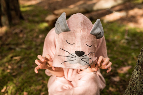 1. Child wearing RÄTT Long-Sleeve Poncho CAT in bamboo terry, featuring cat face hood, outdoors