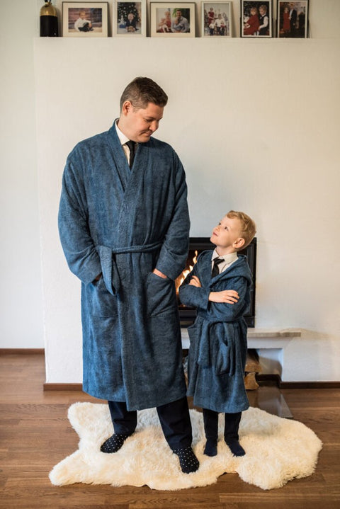 1. Men's bamboo terry bathrobe by RÄTT, worn by adult and child in cozy indoor setting