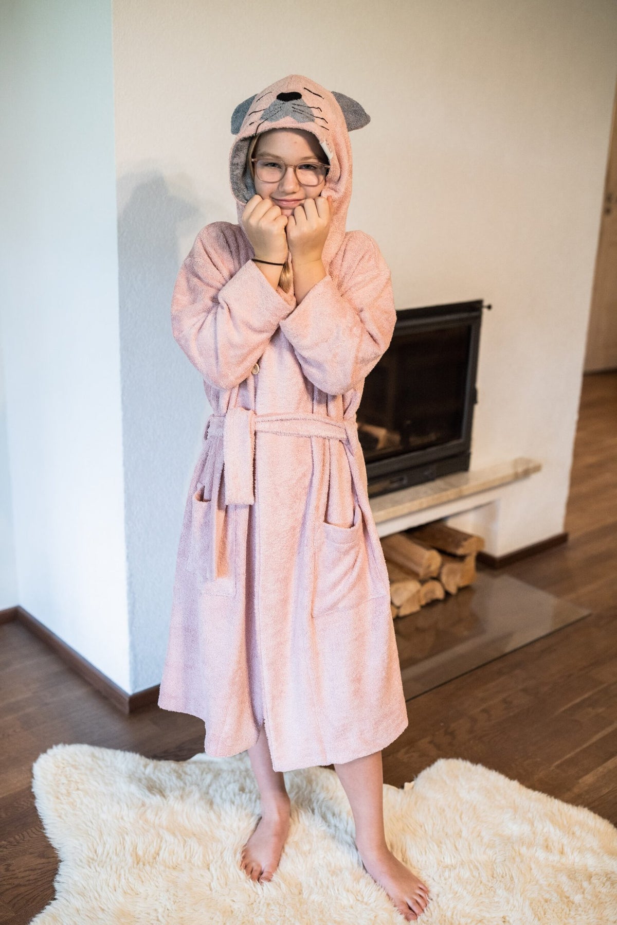 3. Girl in pink RÄTT CAT Bamboo Terry Bathrobe with hood, smiling indoors