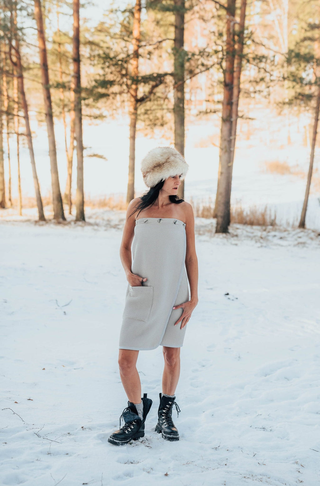 5. Woman in beige RÄTT spa wrap standing in snowy forest, highlighting versatility