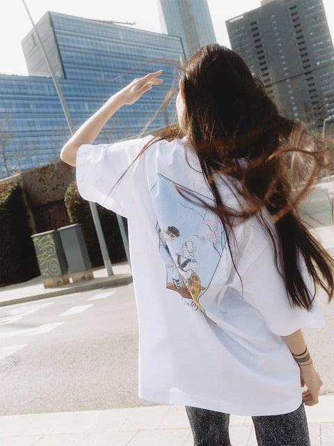 1. Woman wearing Hopera's 'Gentils Propos' t-shirt by George Barbier, shown from the back in an urban setting