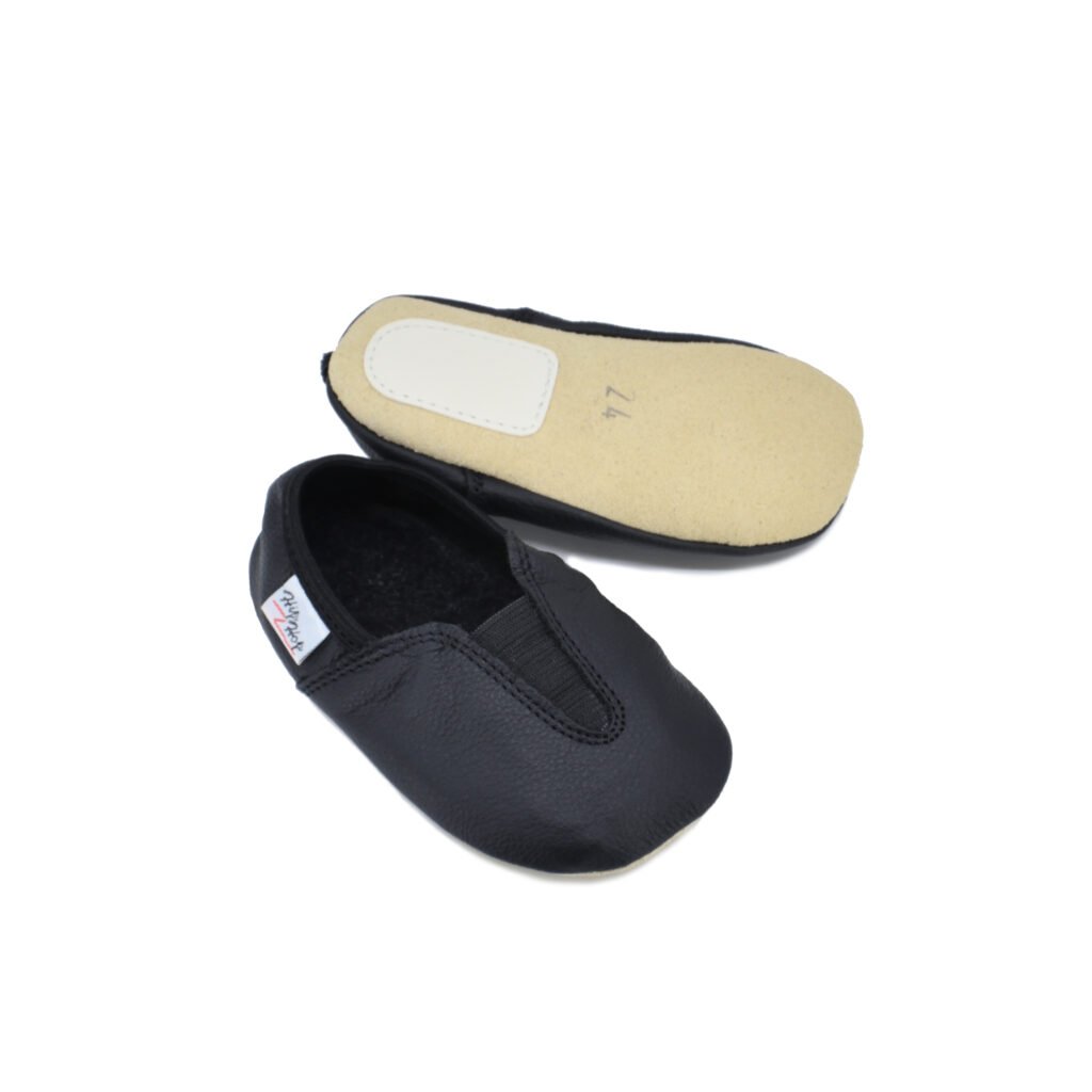 3. Studio image of Hip-Hop Punsa Kids Barefoot Slippers in black, showing top and sole view with soft velour sole