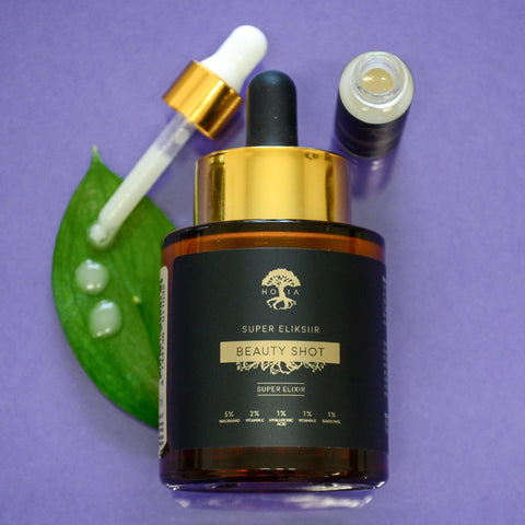 2. HOIA homespa Beauty SHOT Serum 30ml with dropper and small bottle, shown with green leaf and serum drops on purple background