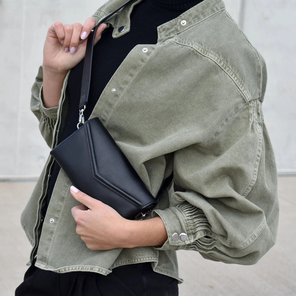 1. Women's black leather waist and shoulder bag by Gerda Retter Design, styled with green jacket