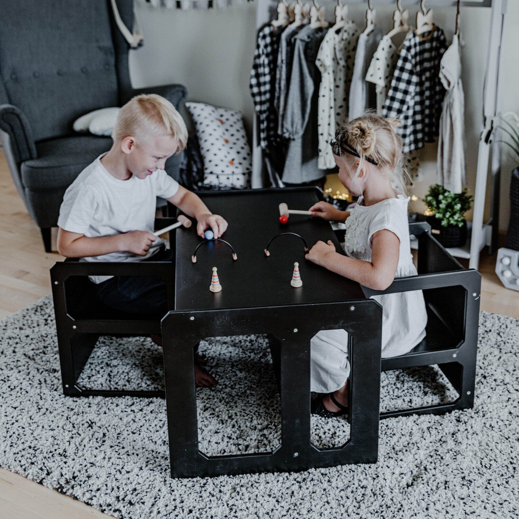 8. Two children playing at black Montessori weaning table and chair set in playroom