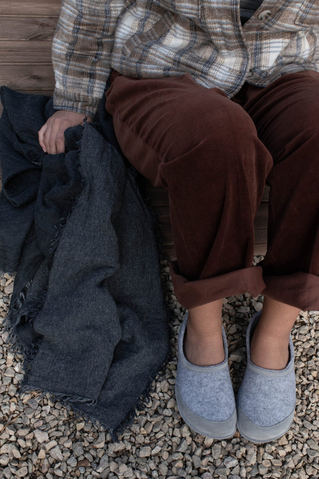 2. Unisex gray felt barefoot indoor slippers by Omaking worn by a seated model with plaid shirt