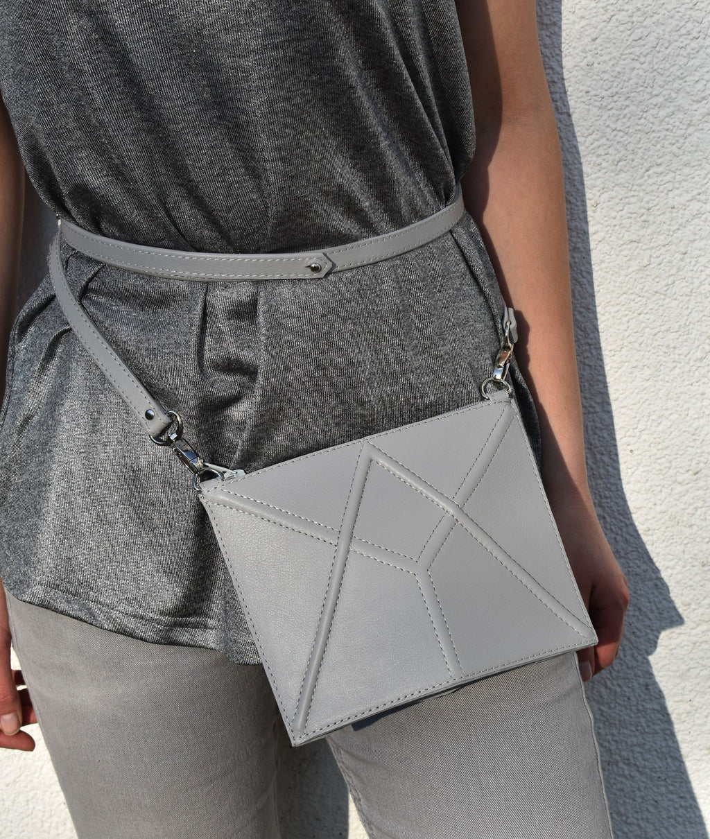 4. Women's light grey FACET Mini leather waist bag by Gerda Retter Design, styled with grey top and pants