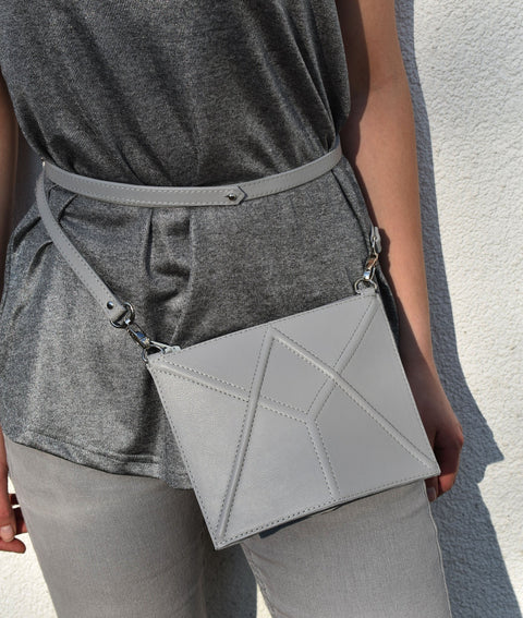 4. Women's light grey FACET Mini leather waist bag by Gerda Retter Design, styled with grey top and pants